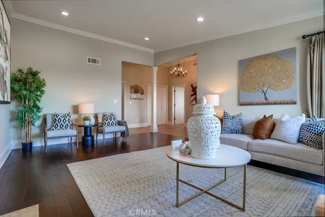 a kitchen with a dining table chairs cabinets and wooden floor