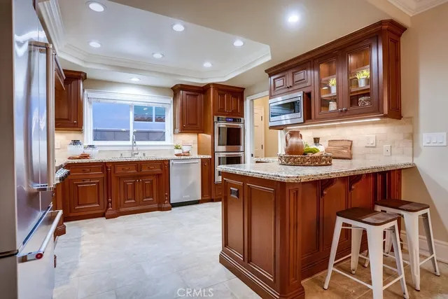 a bathroom with a granite countertop sink a toilet a mirror and shower