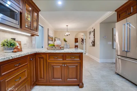 a view of a balcony with chairs and wooden floor