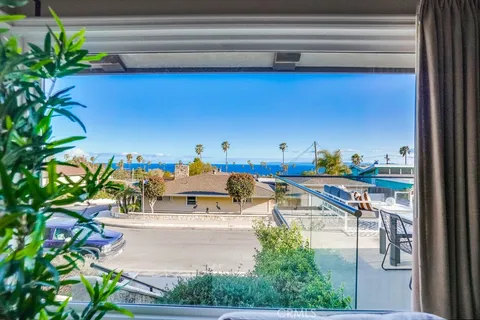 a living room with furniture a chandelier a rug and a window