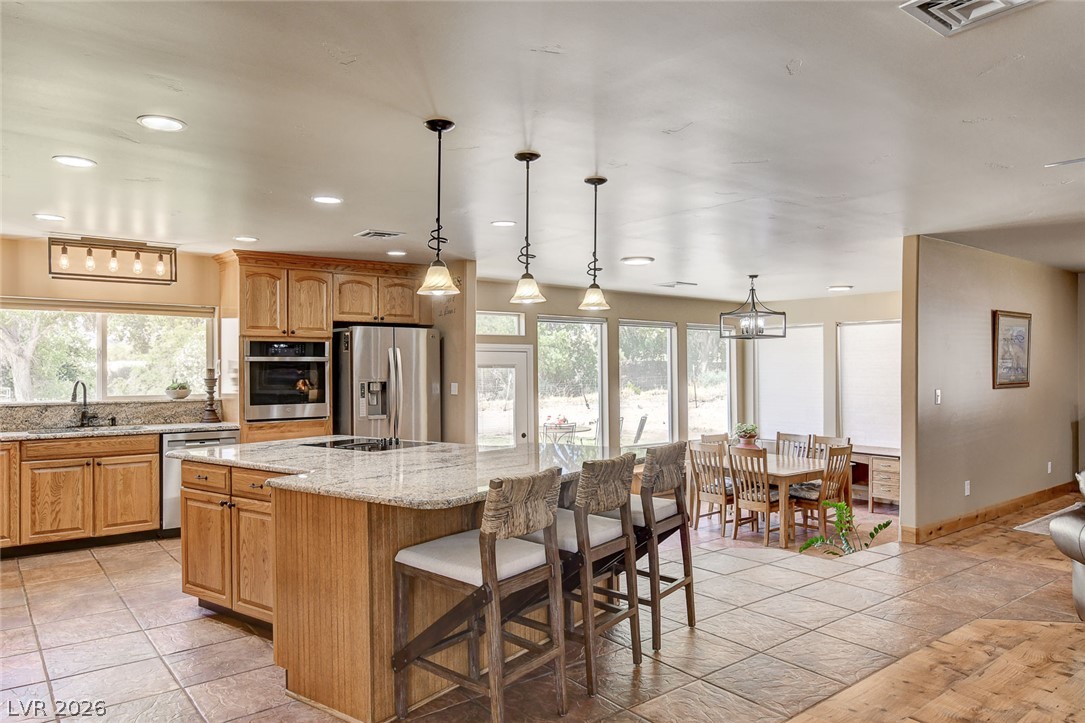 1950 Bowman Road Logandale, NV 89021 - Photo 8 of 98 An inviting kitchen and dining area with abundant natural light and modern amenities.