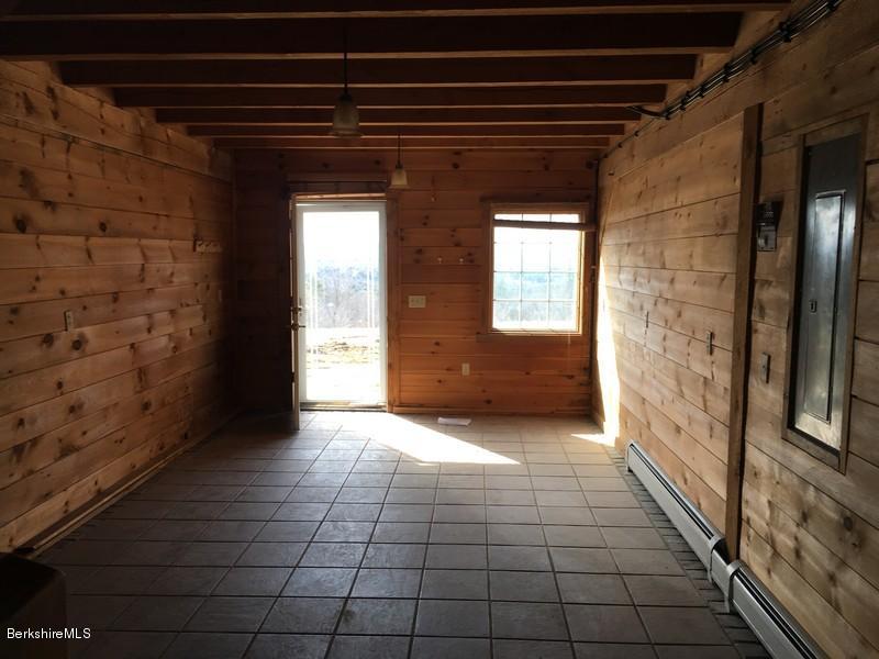75 Hickingbotham Road Peru, MA 01235 - Photo 11 of 32 a view of a hallway to an empty room with a fireplace