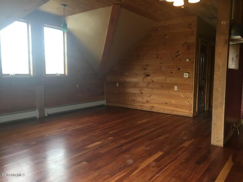 75 Hickingbotham Road Peru, MA 01235 - Photo 12 of 32 an empty room with wooden floor and windows