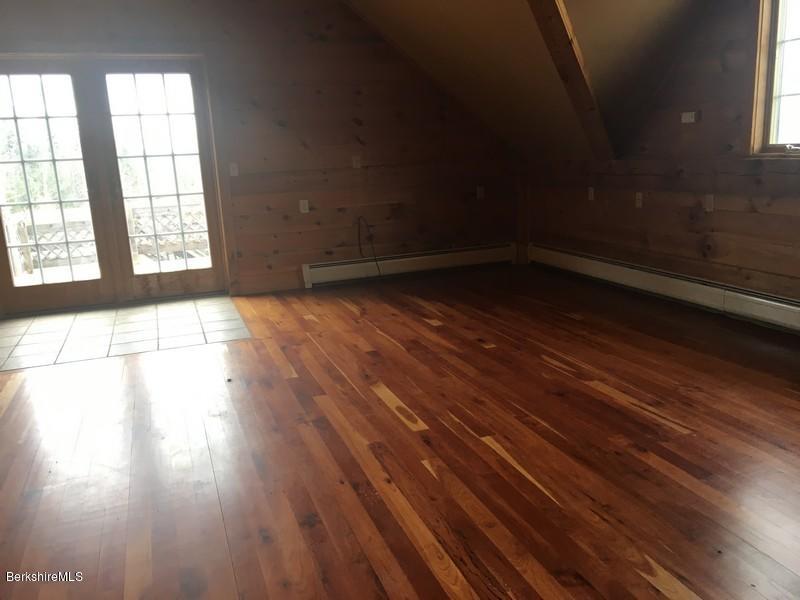 75 Hickingbotham Road Peru, MA 01235 - Photo 14 of 32 an empty room with wooden floor and windows