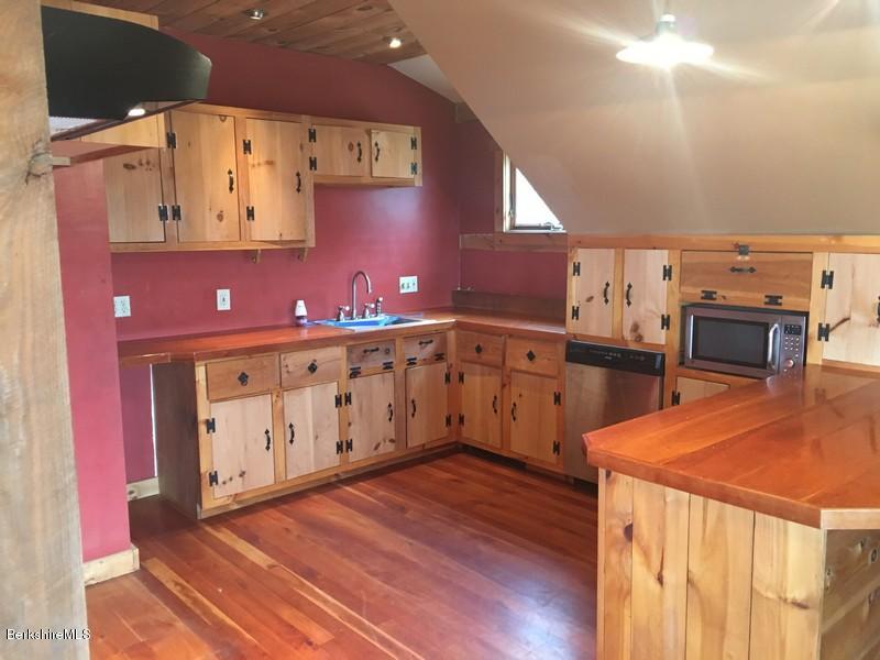 75 Hickingbotham Road Peru, MA 01235 - Photo 15 of 32 a kitchen with cabinets a sink and a stove
