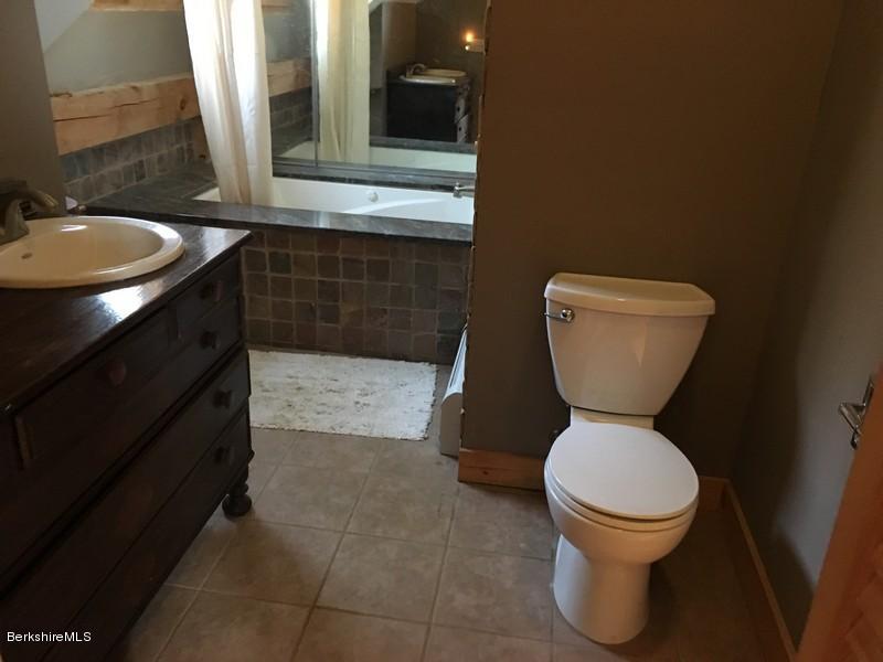 75 Hickingbotham Road Peru, MA 01235 - Photo 20 of 32 a bathroom with a toilet sink and mirror
