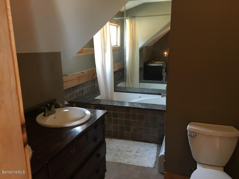 75 Hickingbotham Road Peru, MA 01235 - Photo 21 of 32 a bathroom with a toilet sink and mirror