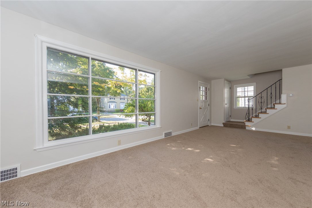 1235 Winston Road Cleveland, OH 44121 - Photo 6 of 30 The spacious and light filled Living Room with a large picture window and new carpet