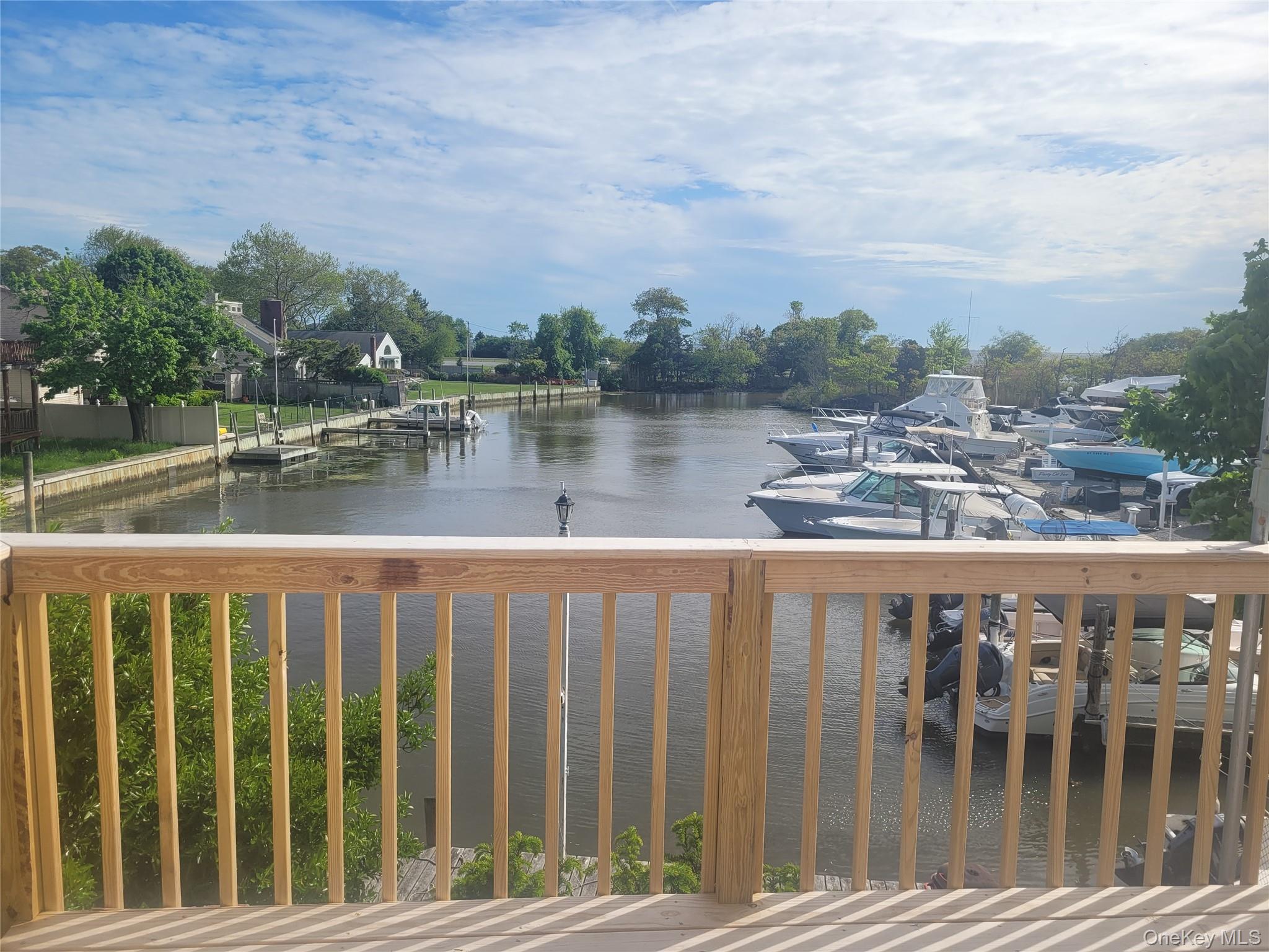 8 Cornell Road East Patchogue, NY 11772 - Photo 2 of 18 a view of a street with a lake view