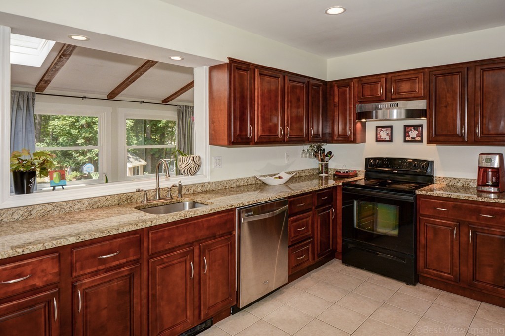 854 Great Road Stow, MA 01775 - Photo 5 of 8 a kitchen with stainless steel appliances granite countertop a sink stove and cabinets