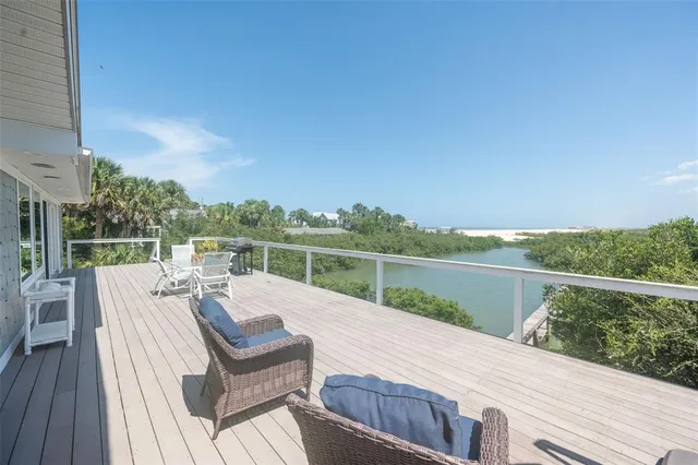 a view of a terrace with couches and wooden floor