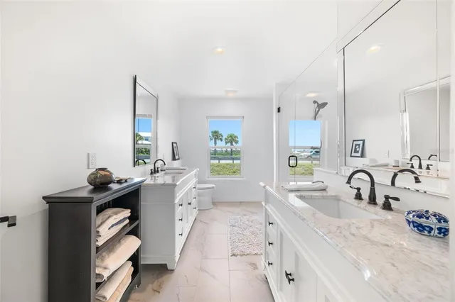 a bathroom with a double vanity sink and mirror