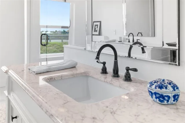 a bathroom with a sink a mirror and a shower