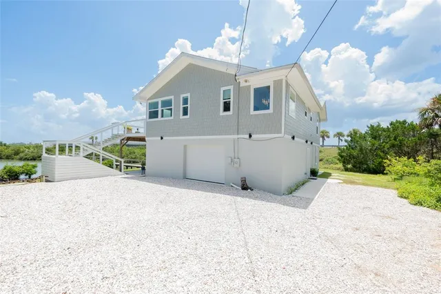 a view of a house with a yard and garage
