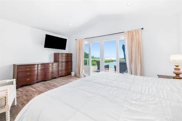 an aerial view of a residential houses with outdoor space and lake view