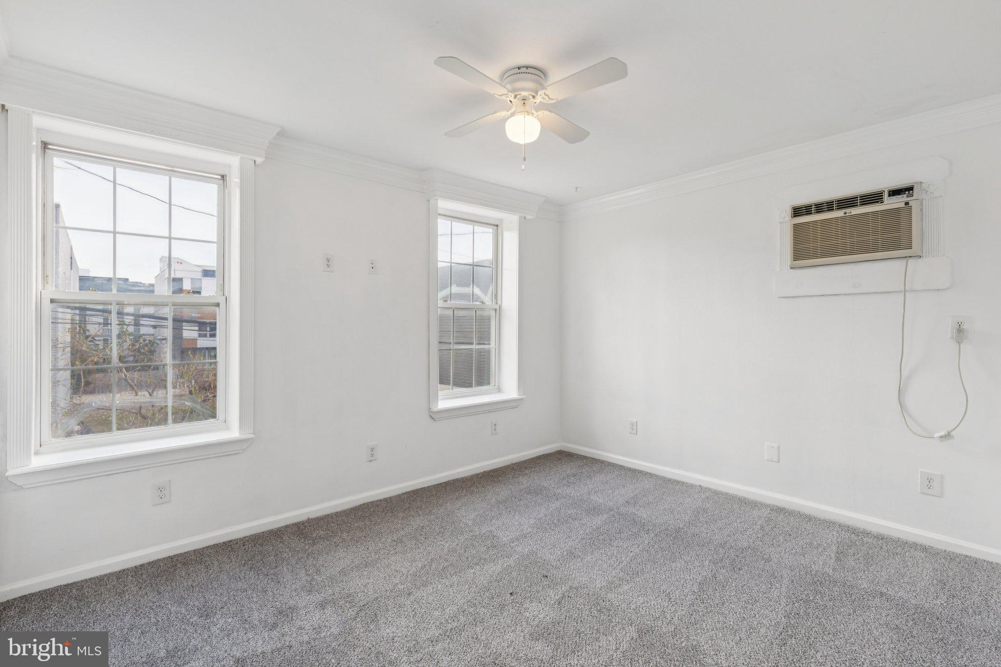 1444 North Perth Street Philadelphia, PA 19122 - Photo 16 of 27 an empty room with a window and a fan