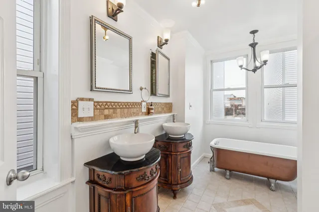 a bathroom with a granite countertop tub and a sink