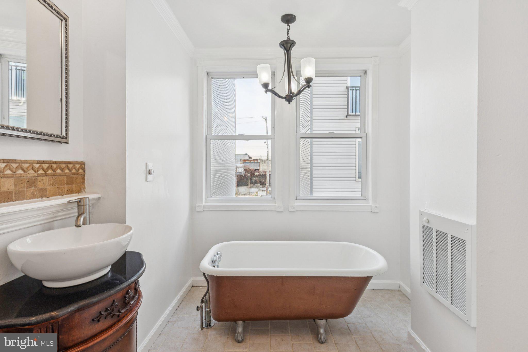 1444 North Perth Street Philadelphia, PA 19122 - Photo 18 of 27 a bathroom with a granite countertop tub and a sink