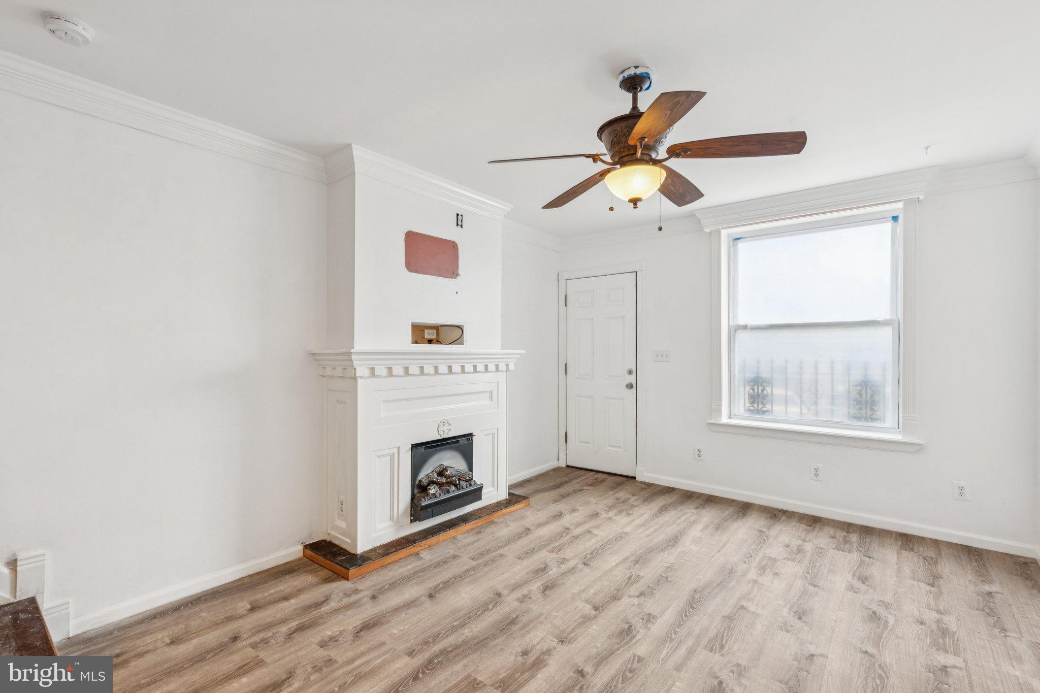 1444 North Perth Street Philadelphia, PA 19122 - Photo 3 of 27 a view of empty room with fireplace and fan