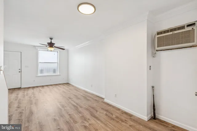 an empty room with windows and cabinet