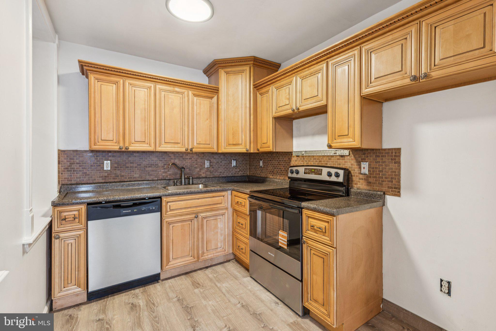 1444 North Perth Street Philadelphia, PA 19122 - Photo 8 of 27 a kitchen with stainless steel appliances granite countertop a stove a sink and a microwave