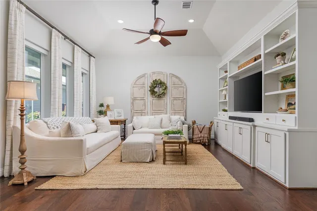 a living room with furniture fireplace and flat screen tv