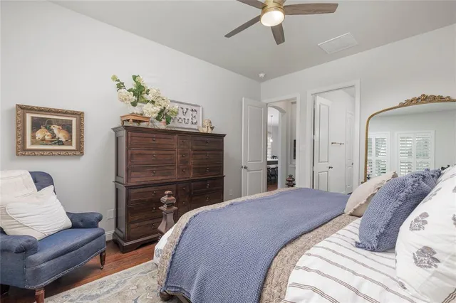 a bedroom with a bed and ceiling fan