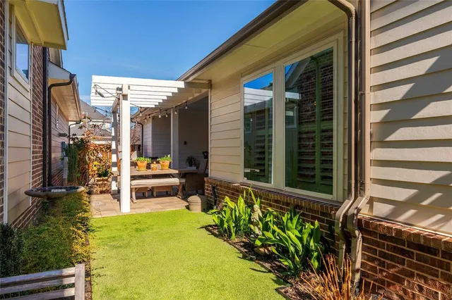 a view of a dining room with furniture and a potted plant