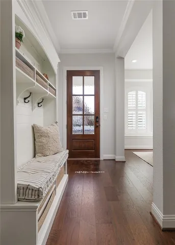 a view of a dining room with furniture wooden floor and a chandelier