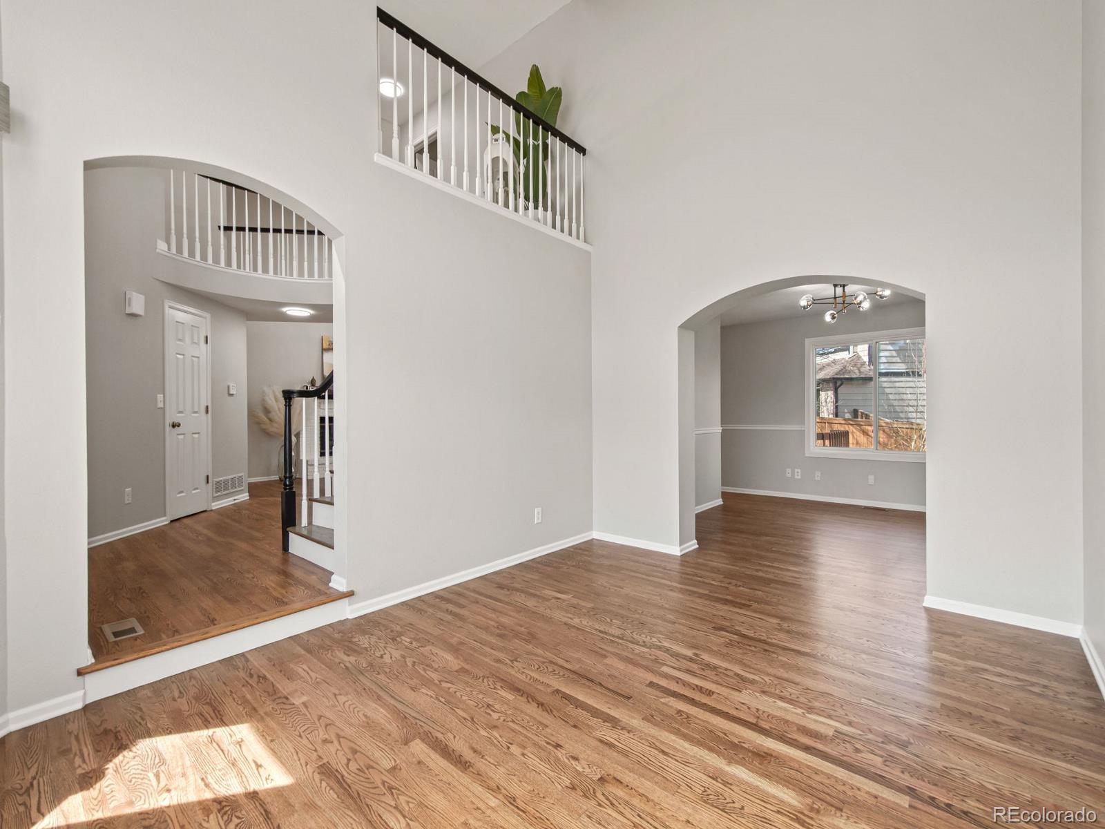 9358 Cornell Circle Highlands Ranch, CO 80130 - Photo 11 of 50 a view of a hallway view with wooden floor and staircase