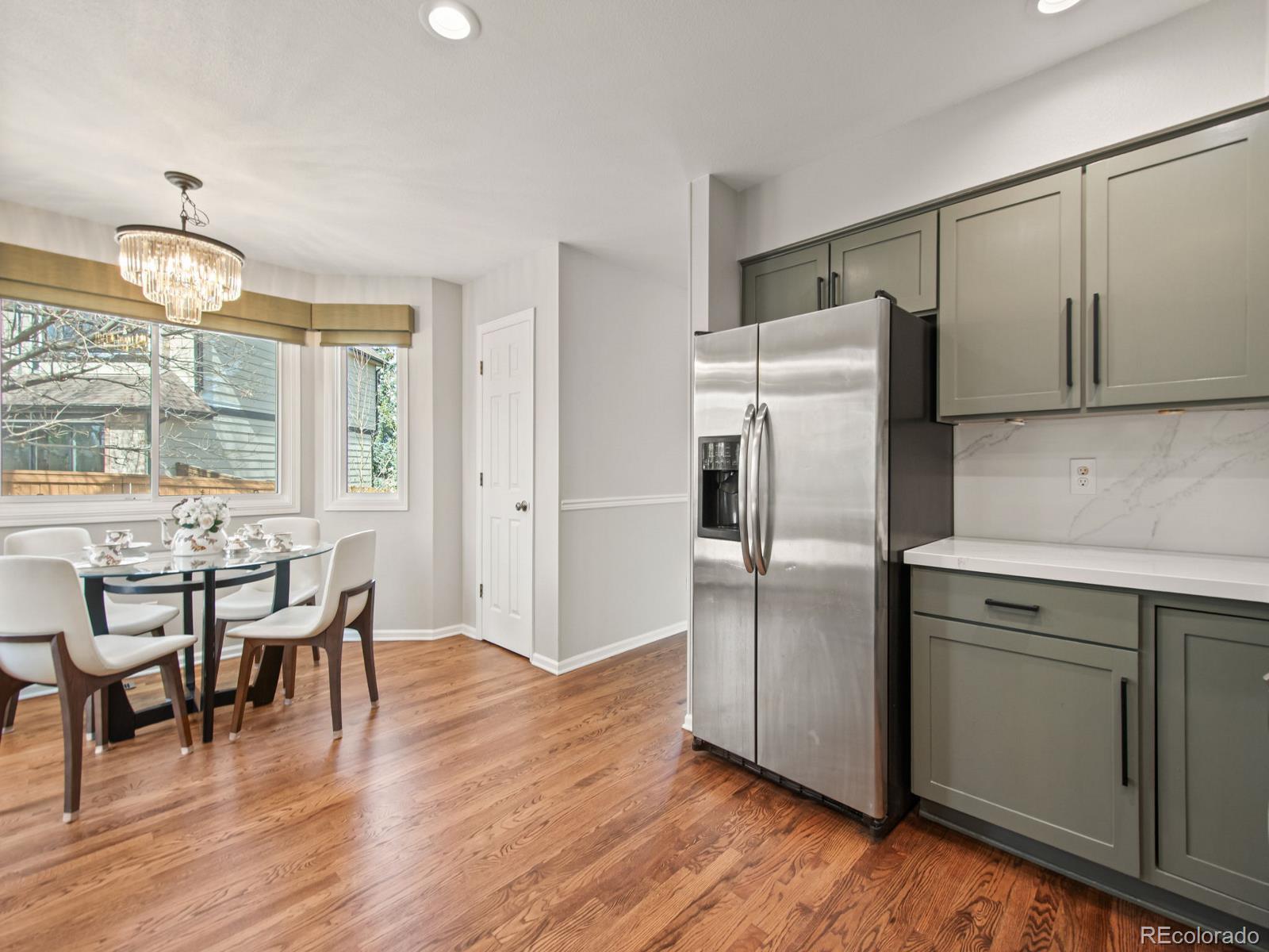 9358 Cornell Circle Highlands Ranch, CO 80130 - Photo 17 of 50 a kitchen with granite countertop cabinets and wooden floor