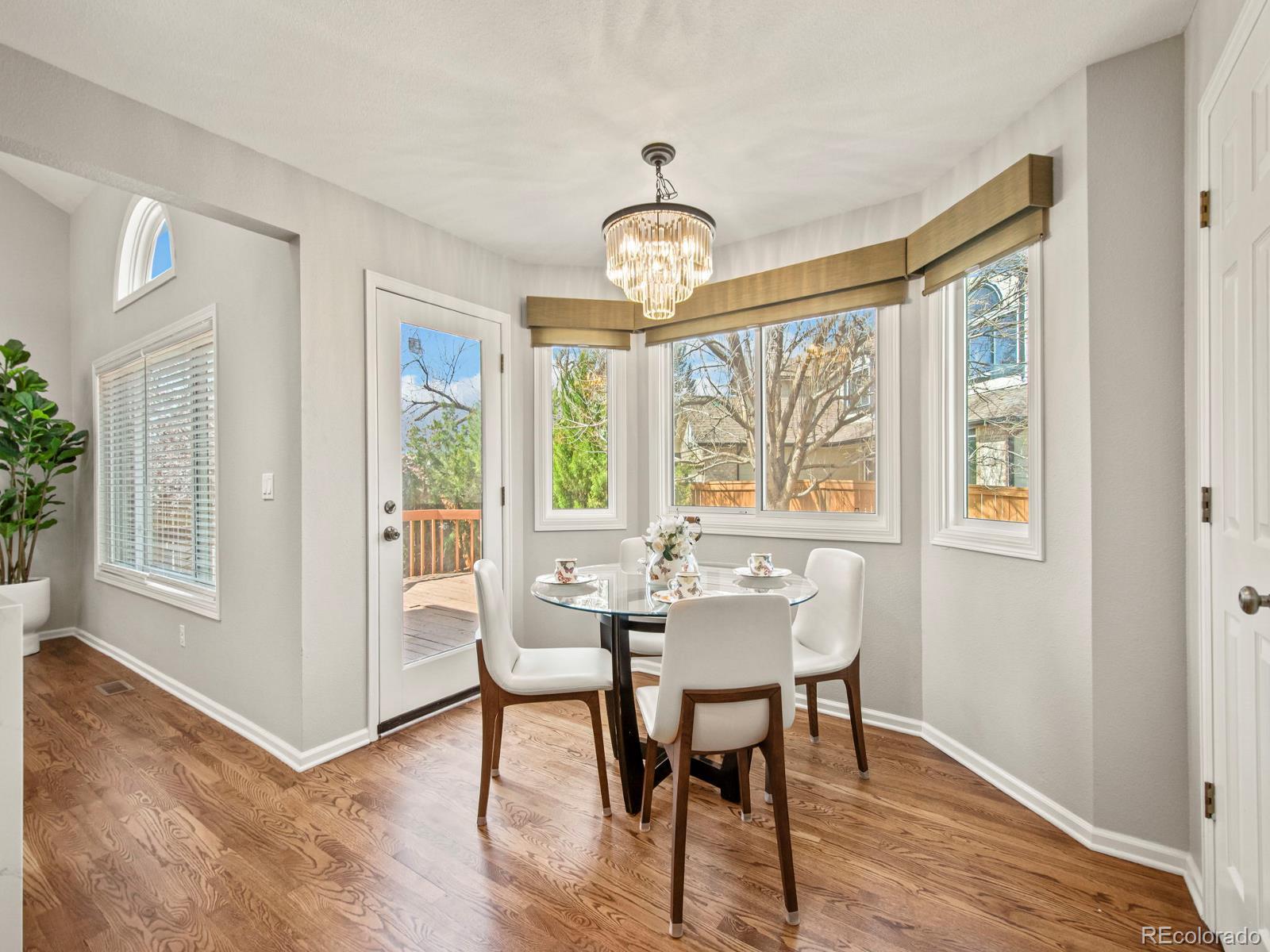 9358 Cornell Circle Highlands Ranch, CO 80130 - Photo 19 of 50 a view of a dining room with furniture window and wooden floor