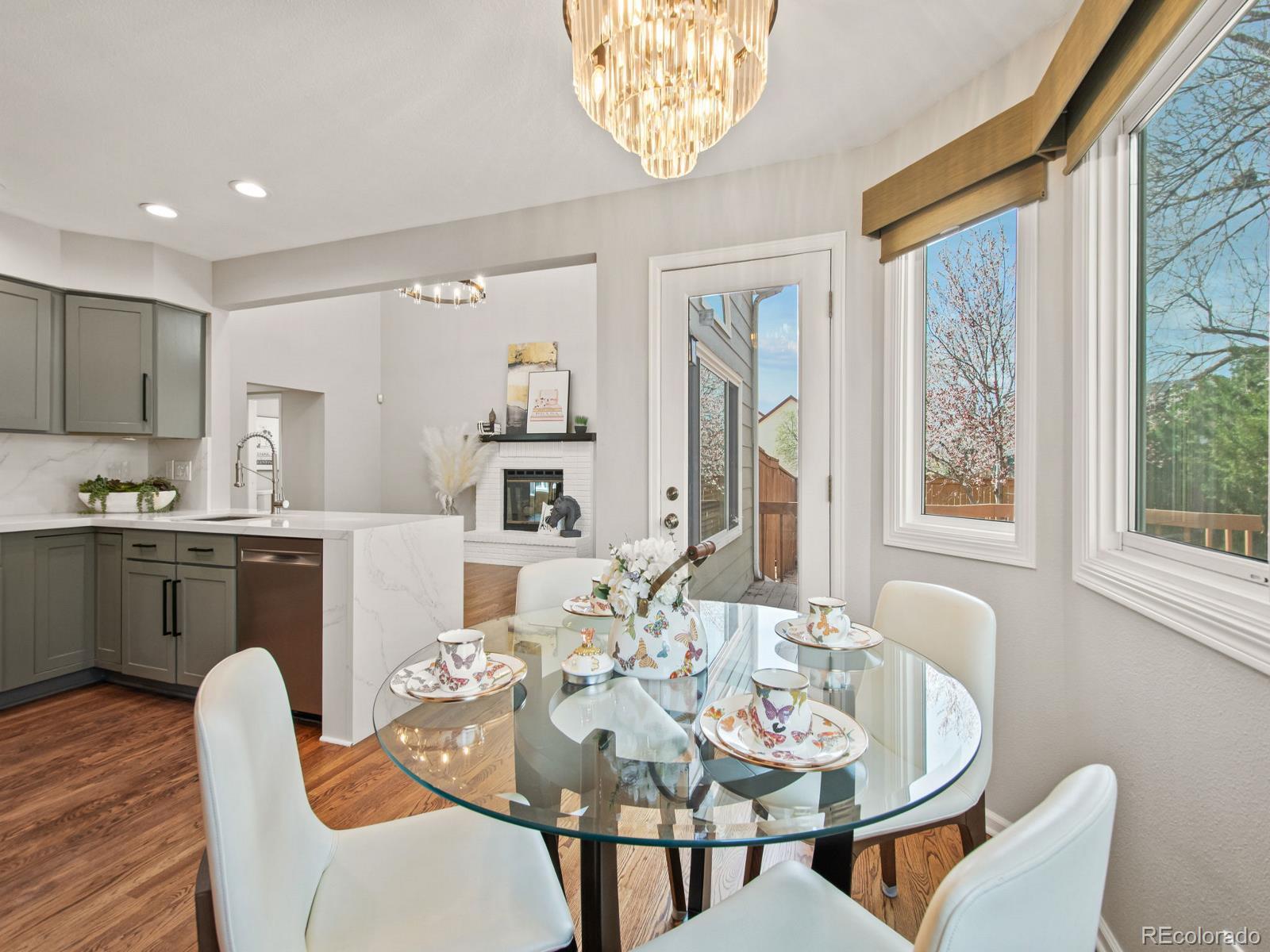 9358 Cornell Circle Highlands Ranch, CO 80130 - Photo 20 of 50 a dining room with furniture a large window and stainless steel appliances