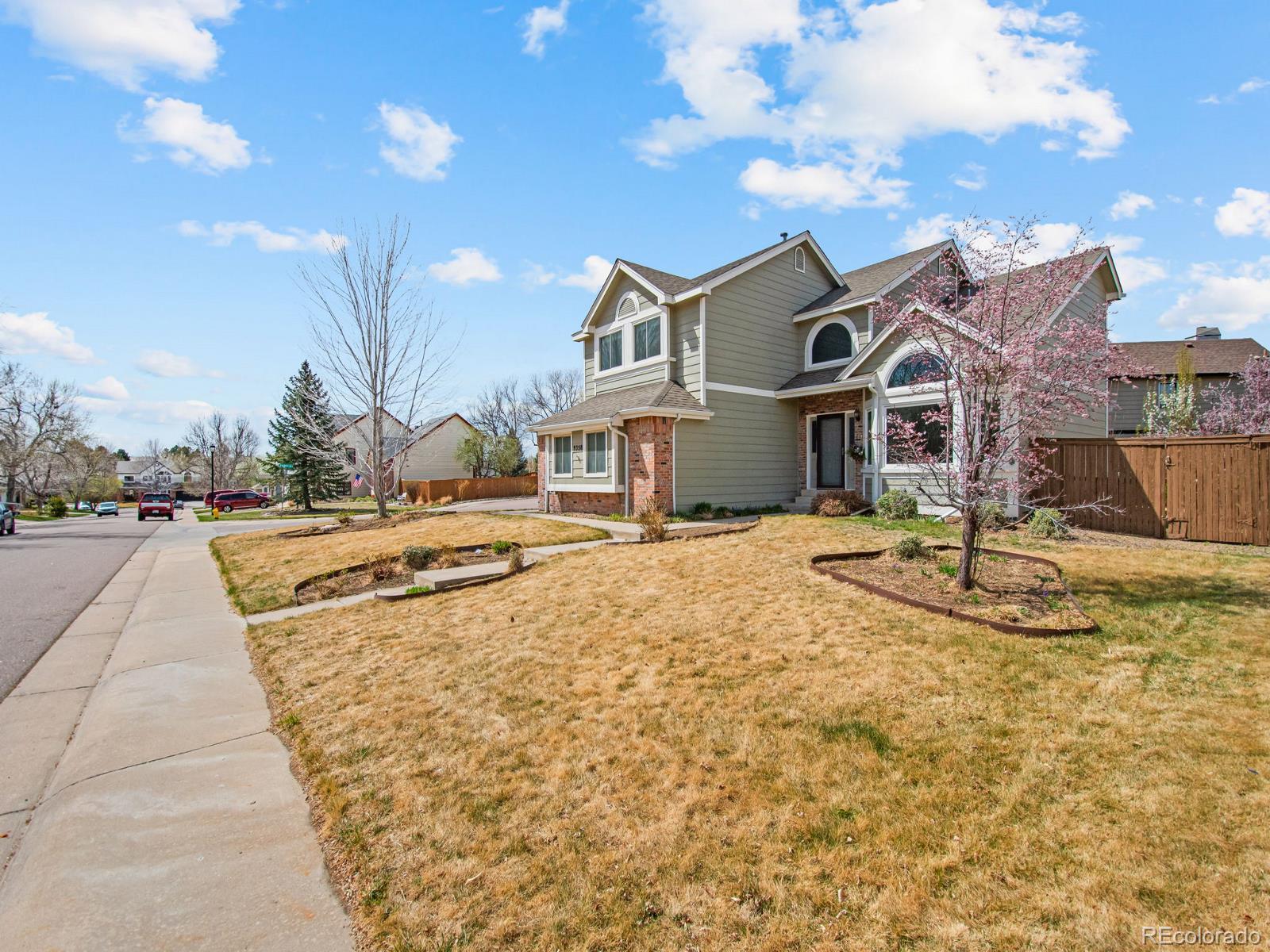 9358 Cornell Circle Highlands Ranch, CO 80130 - Photo 2 of 50 a view of the house with a yard