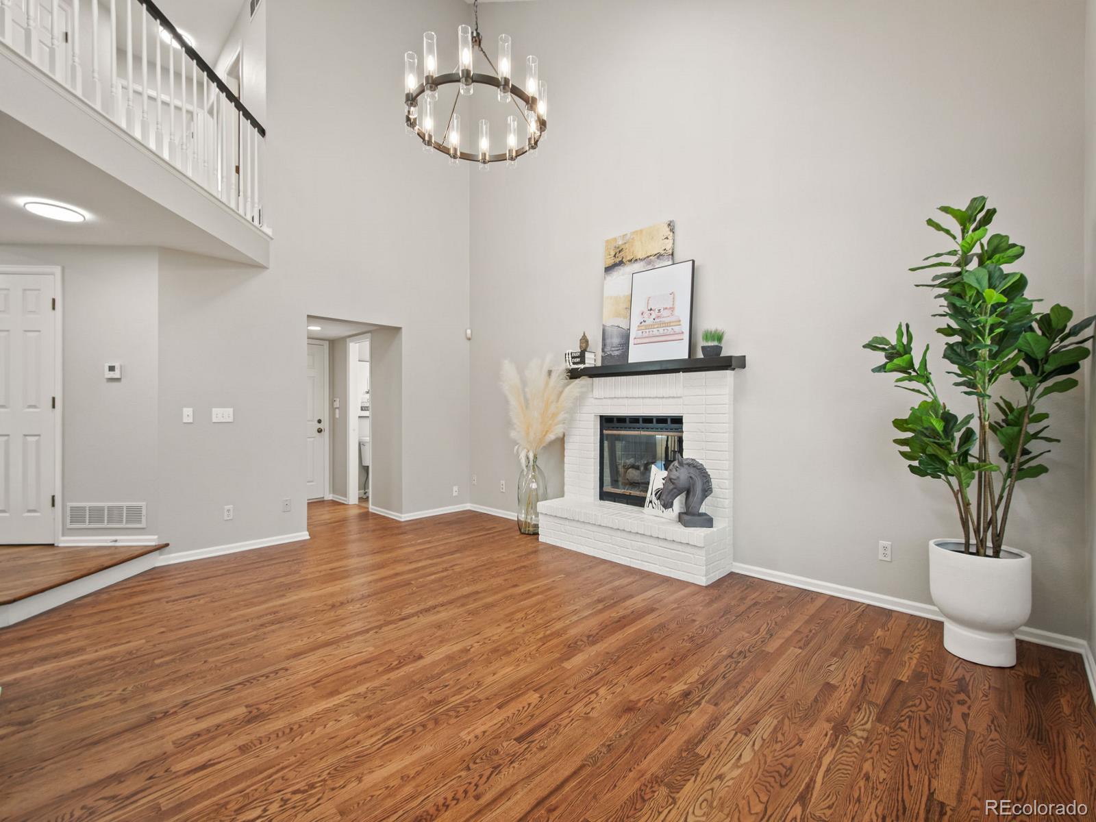 9358 Cornell Circle Highlands Ranch, CO 80130 - Photo 21 of 50 a view of empty room with wooden floor and window