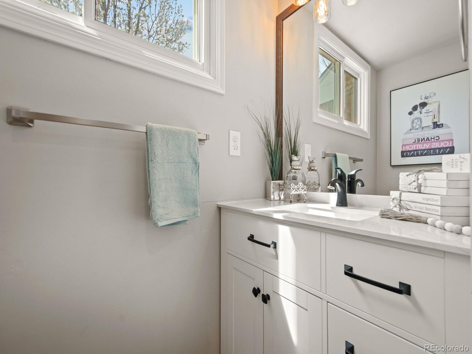 9358 Cornell Circle Highlands Ranch, CO 80130 - Photo 25 of 50 a bathroom with a sink and a mirror