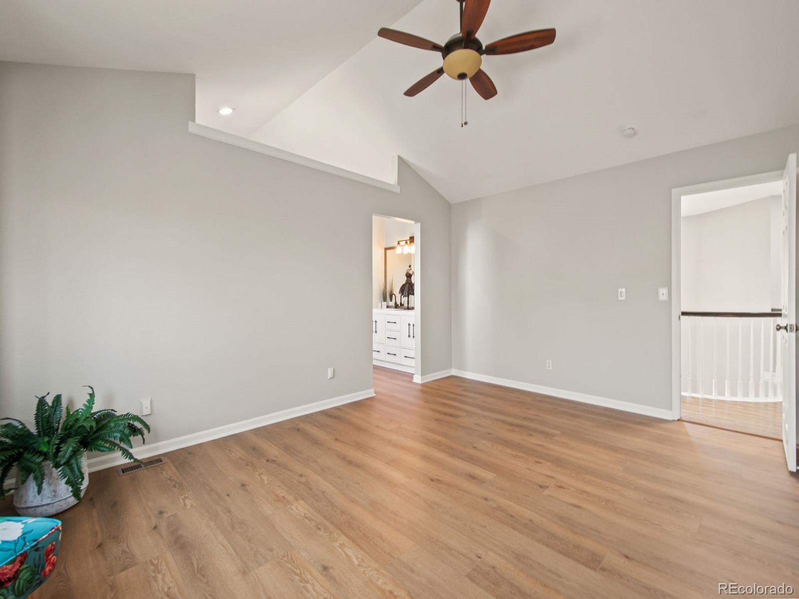 9358 Cornell Circle Highlands Ranch, CO 80130 - Photo 30 of 50 a view of empty room with wooden floor and potted plant