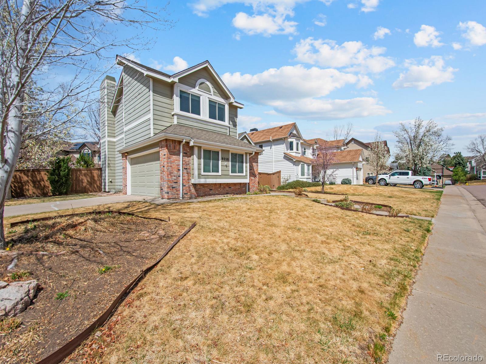 9358 Cornell Circle Highlands Ranch, CO 80130 - Photo 3 of 50 a front view of a house with a yard