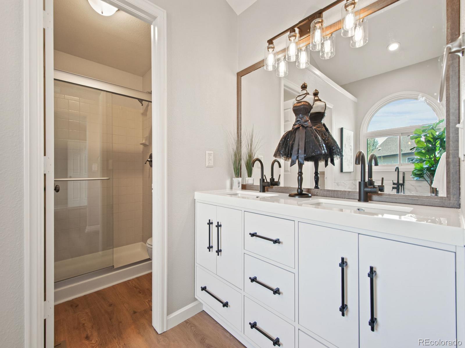 9358 Cornell Circle Highlands Ranch, CO 80130 - Photo 31 of 50 a bathroom with a double vanity sink and a mirror