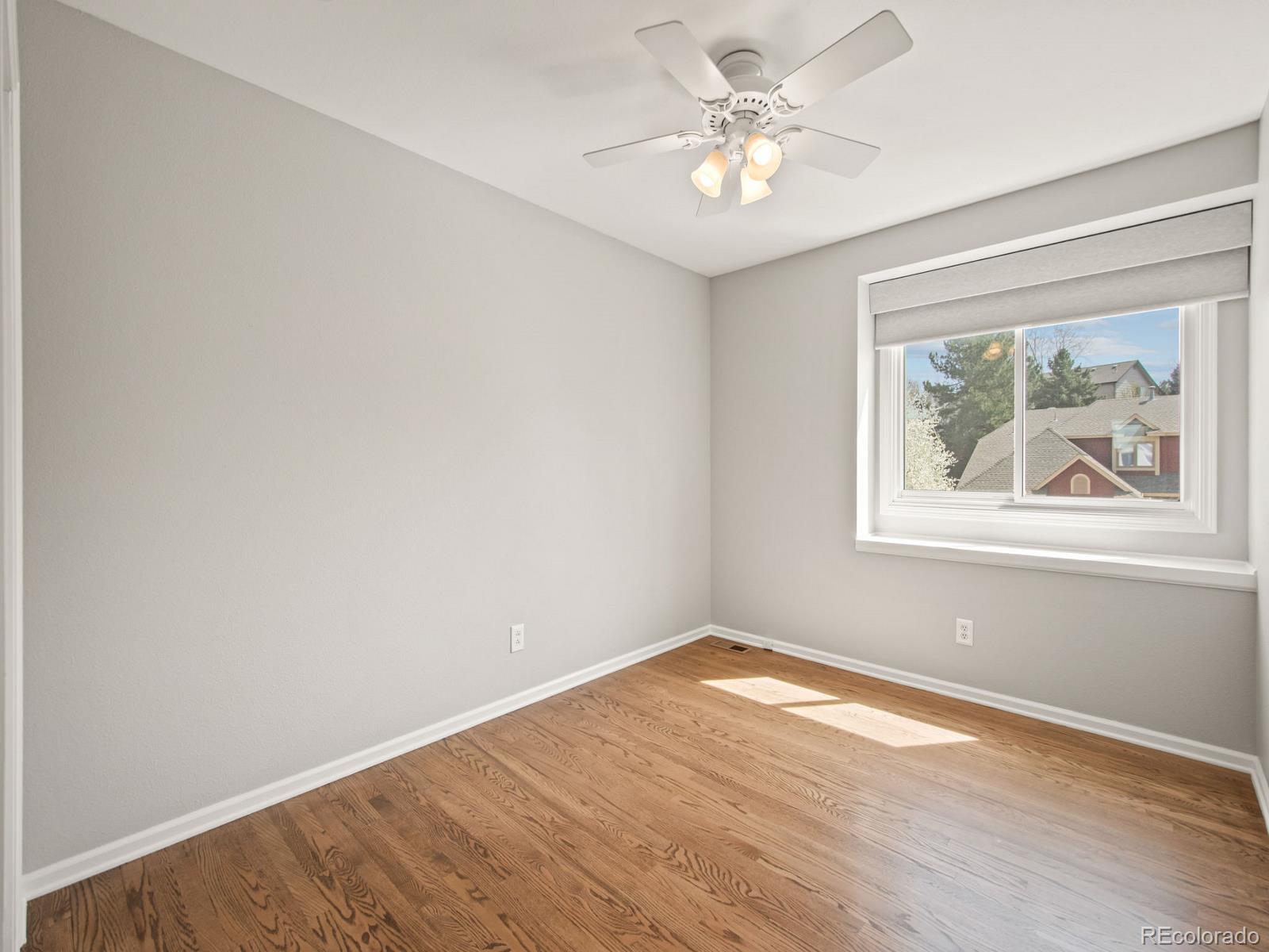 9358 Cornell Circle Highlands Ranch, CO 80130 - Photo 34 of 50 a view of empty room with wooden floor and fan
