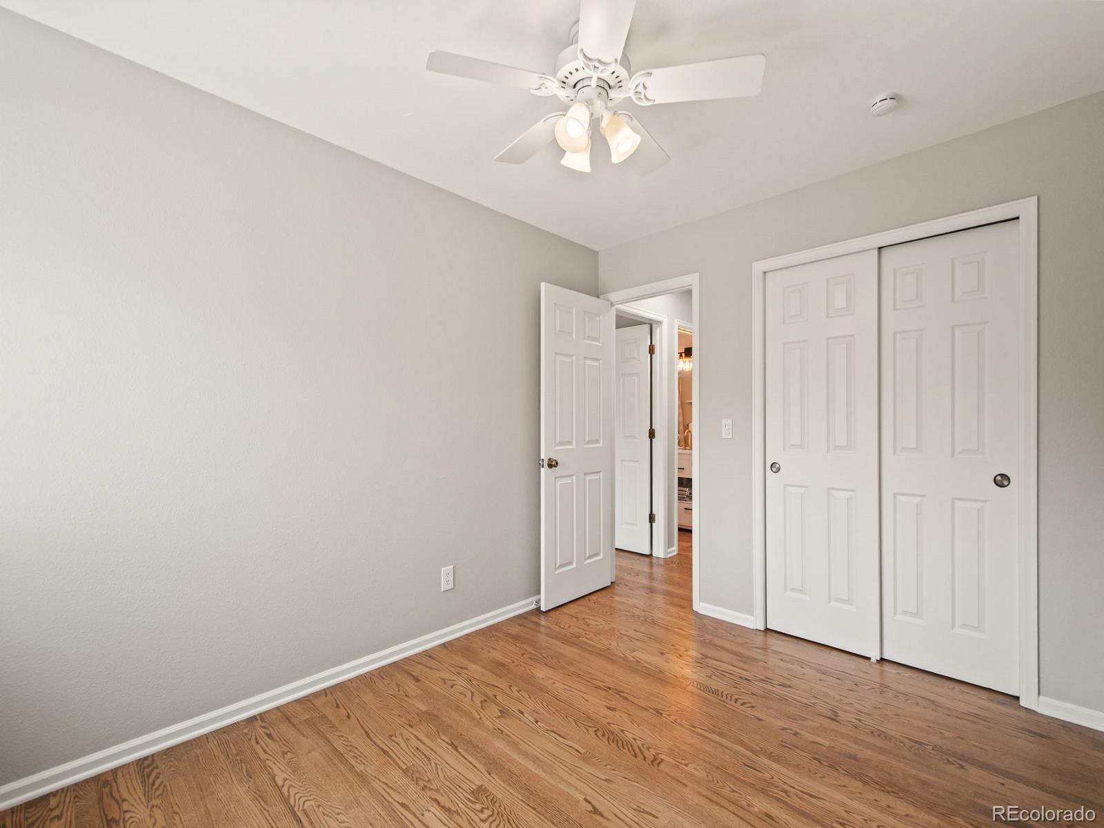 9358 Cornell Circle Highlands Ranch, CO 80130 - Photo 35 of 50 a view of an empty room with wooden floor