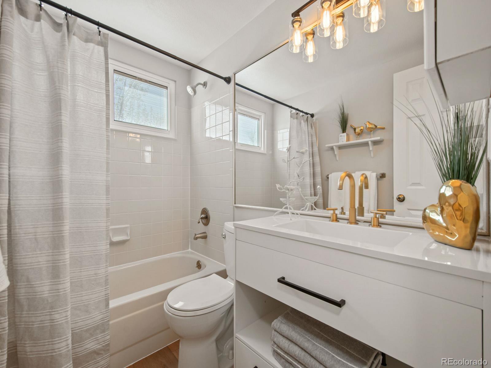 9358 Cornell Circle Highlands Ranch, CO 80130 - Photo 38 of 50 a bathroom with a sink a toilet and shower