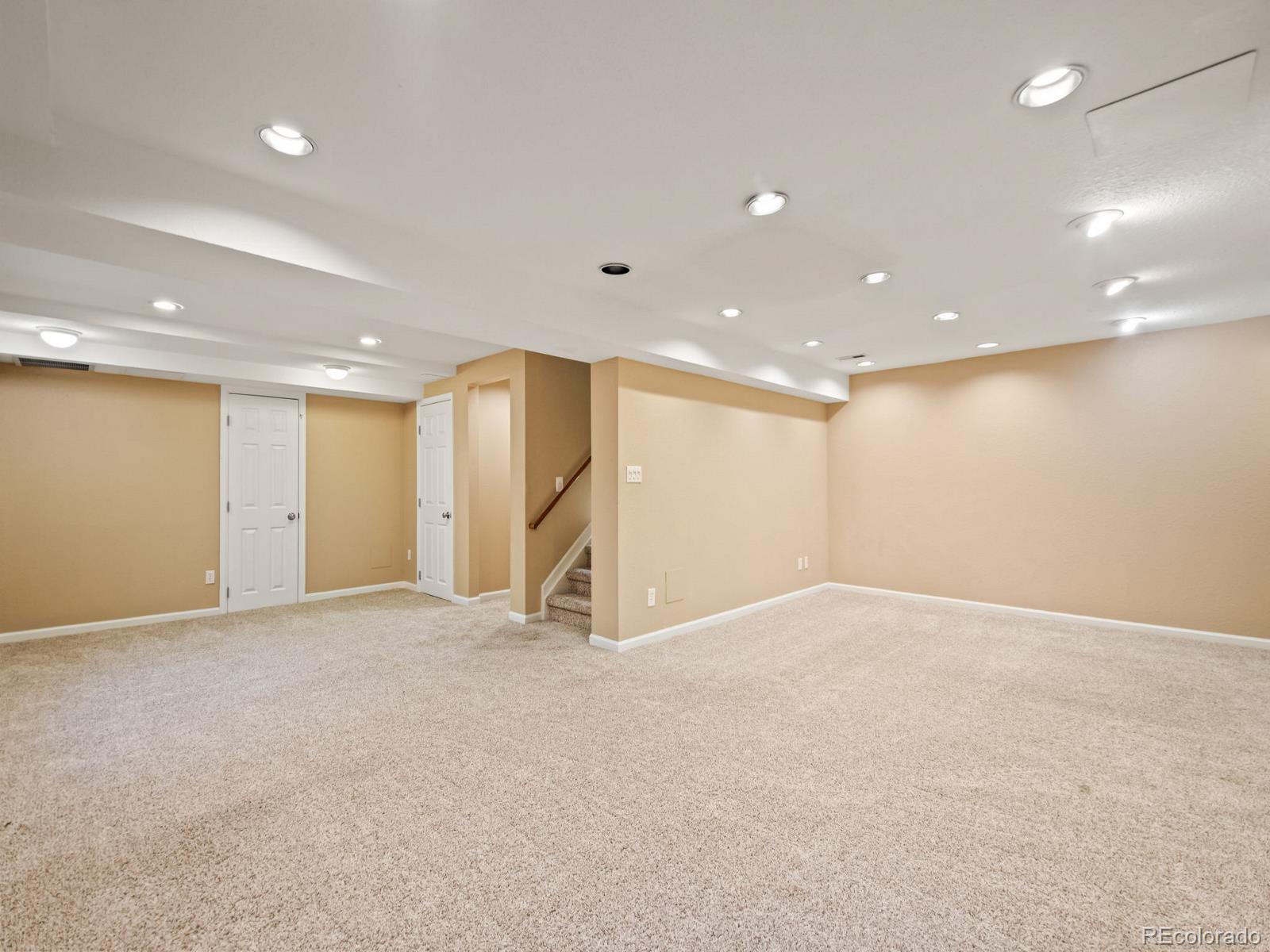 9358 Cornell Circle Highlands Ranch, CO 80130 - Photo 41 of 50 an empty room with a projector and furniture