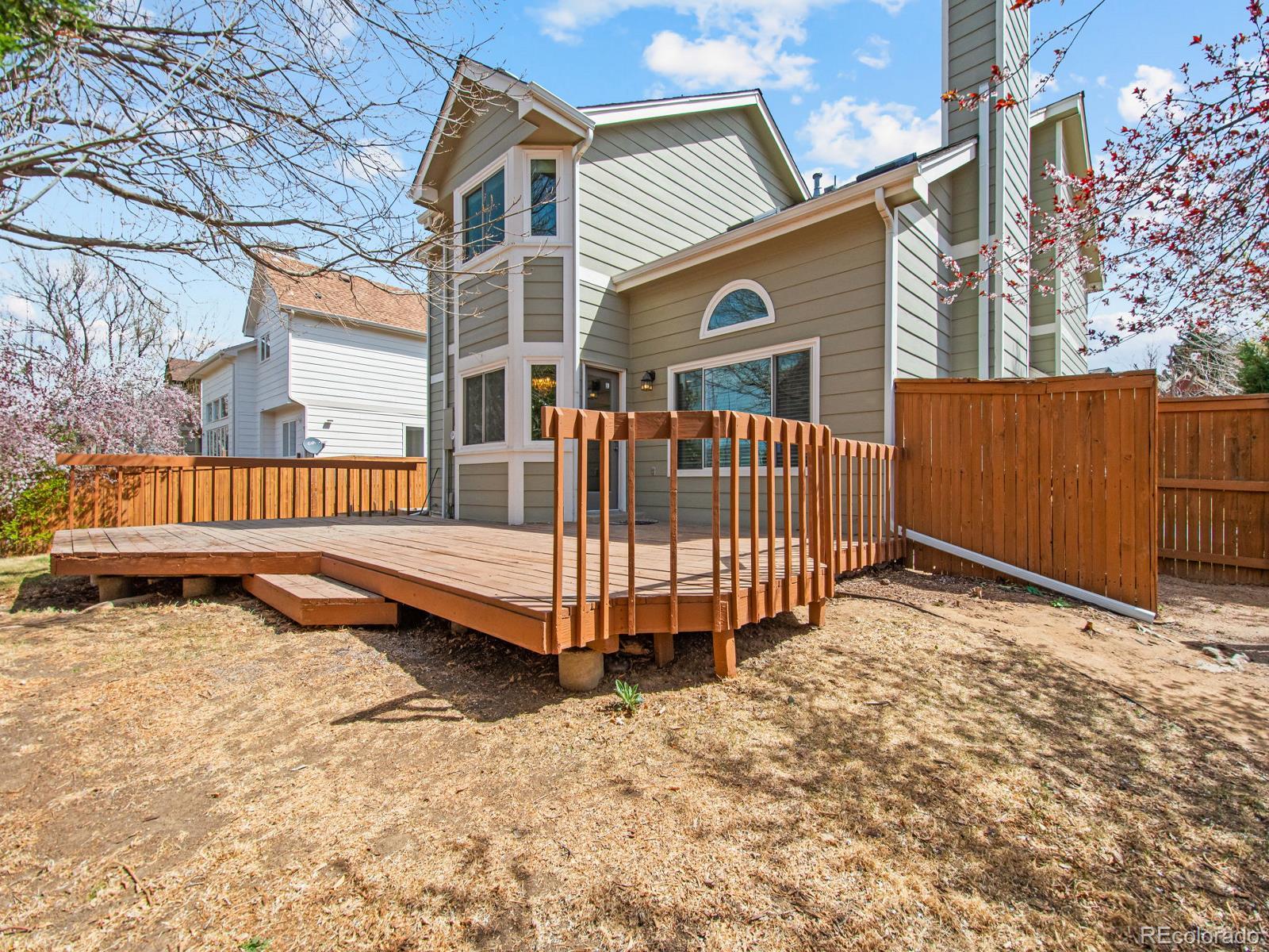 9358 Cornell Circle Highlands Ranch, CO 80130 - Photo 46 of 50 a view of a house with wooden fence and a bench