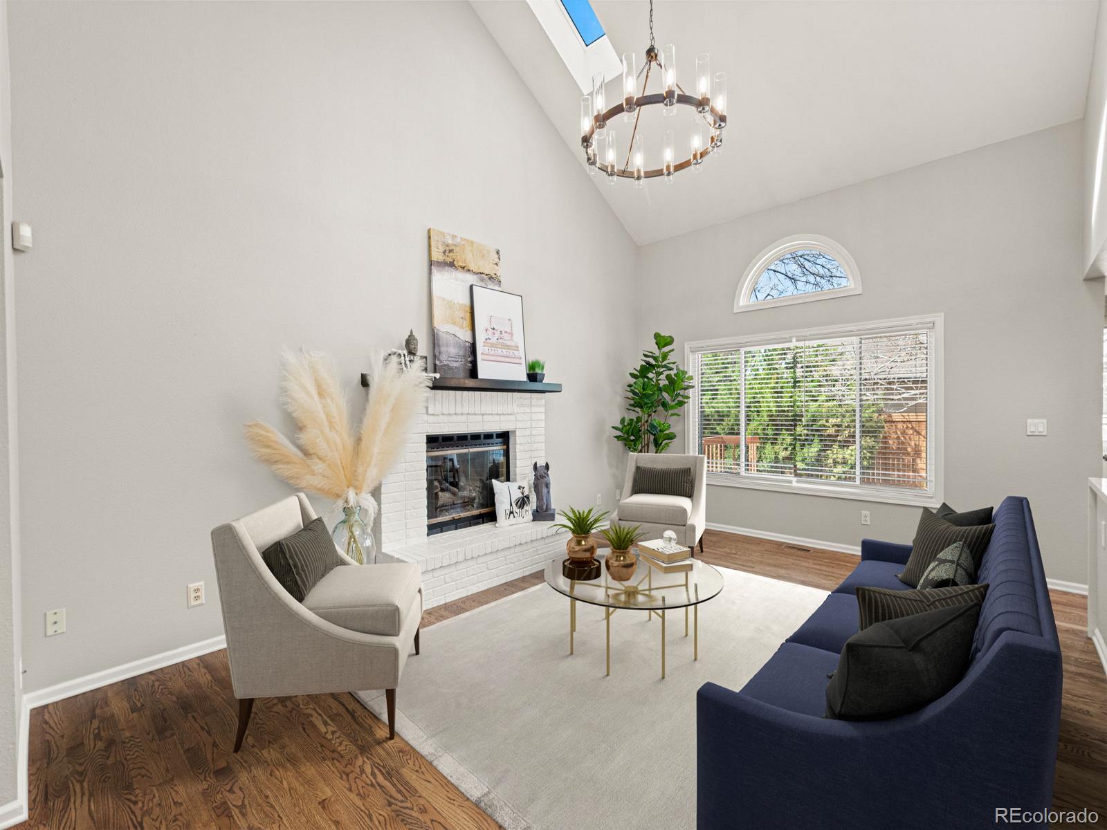 9358 Cornell Circle Highlands Ranch, CO 80130 - Photo 8 of 50 a living room with furniture chandelier and a window