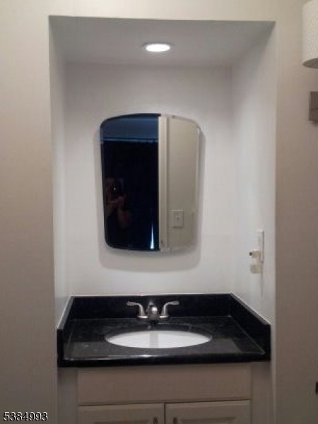 1 Carriage Way, Unit 12 Montclair, NJ 07042 - Photo 11 of 19 a bathroom with a sink and a mirror