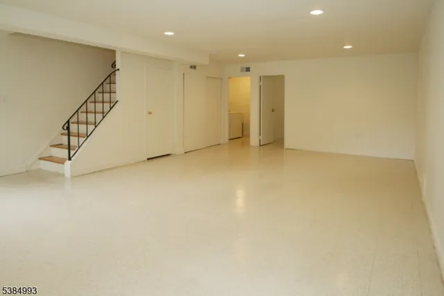 a view of an empty room with stairs