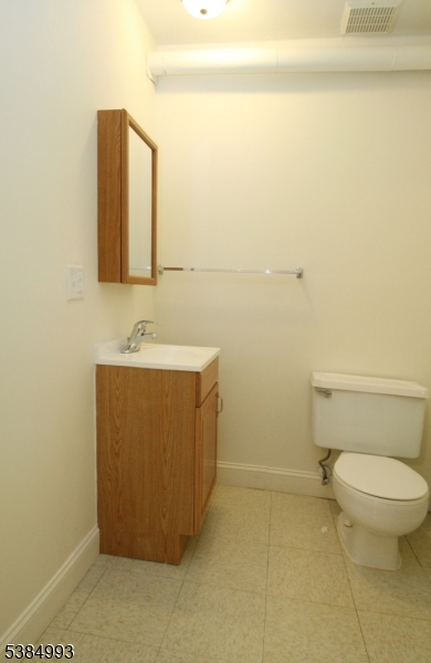 1 Carriage Way, Unit 12 Montclair, NJ 07042 - Photo 19 of 19 a bathroom with a sink a toilet and mirror