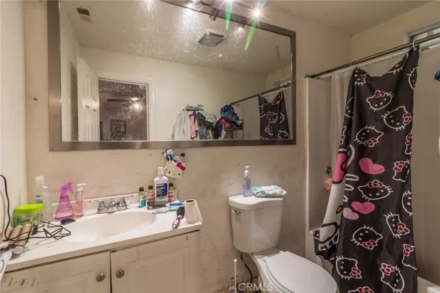 a bathroom with a sink mirror and toilet