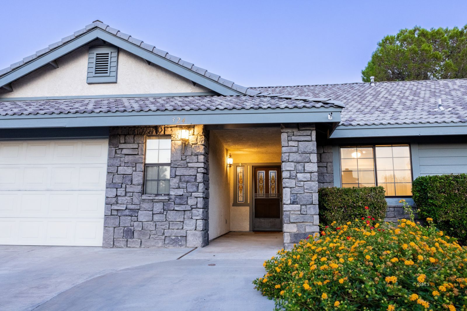 324 West Pilgrim Court Ridgecrest, CA 93555 - Photo 4 of 37 a view of a house with potted plants